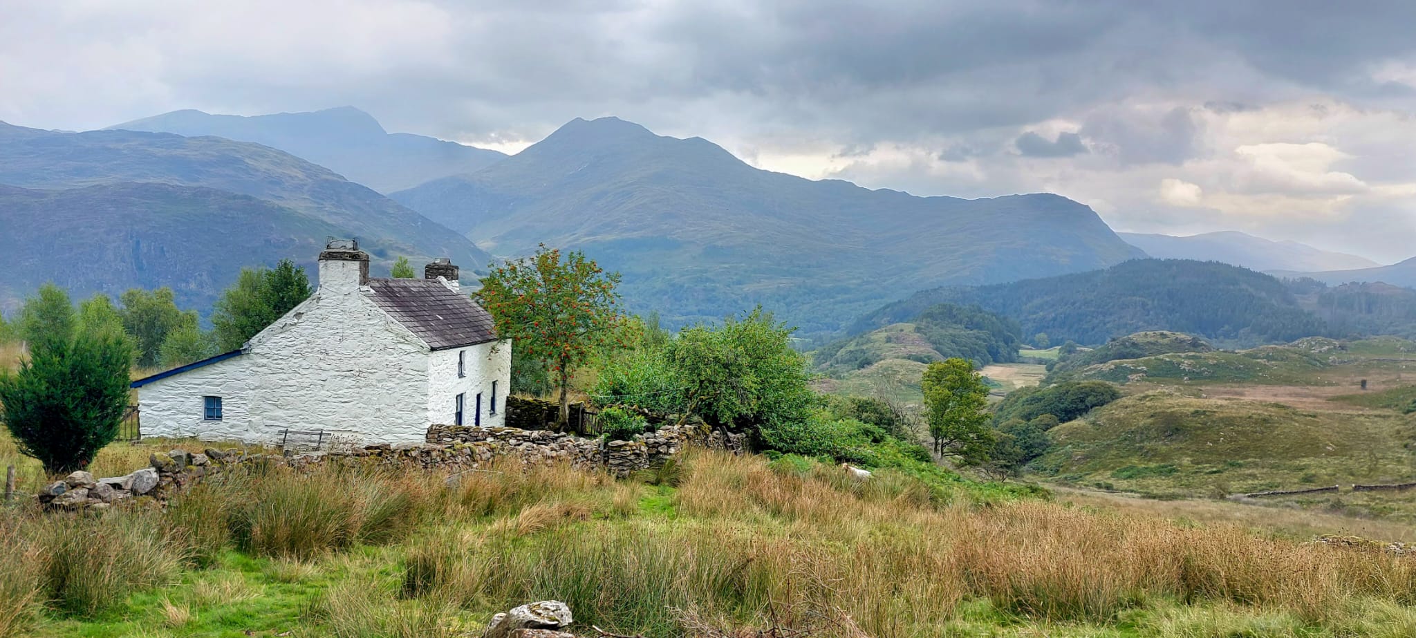 A whitewashed cottage below the mountains