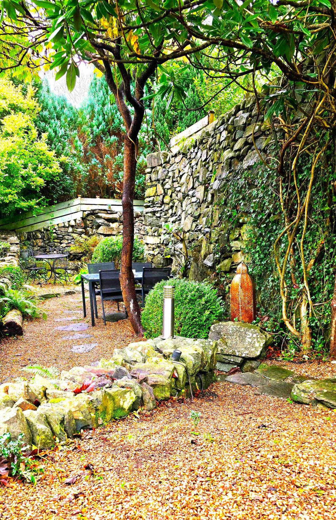 Seating among the dry-stone walls in the terraced back garden