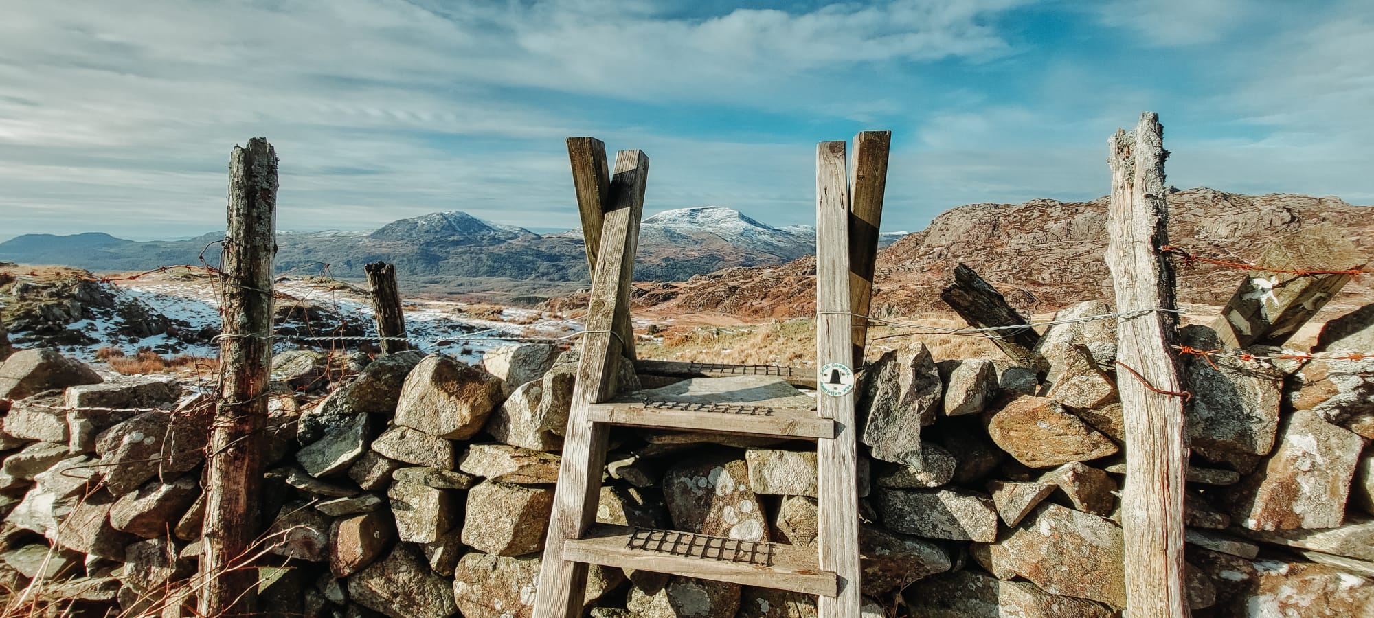 A stile on a winter mountain walk